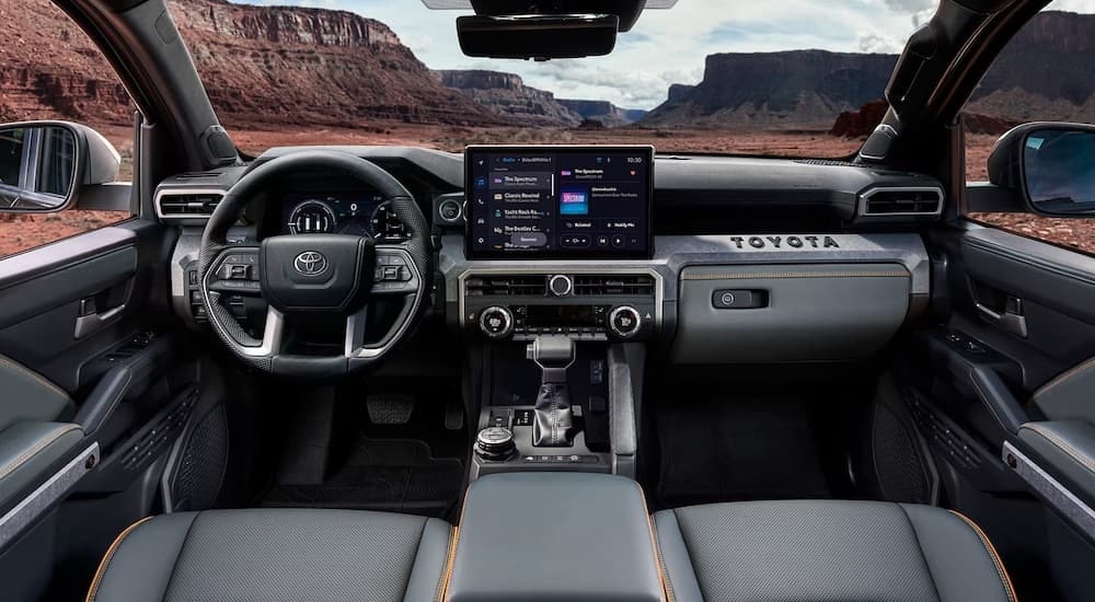 The black interior of a 2024 Toyota Tacoma is shown from above the center console.