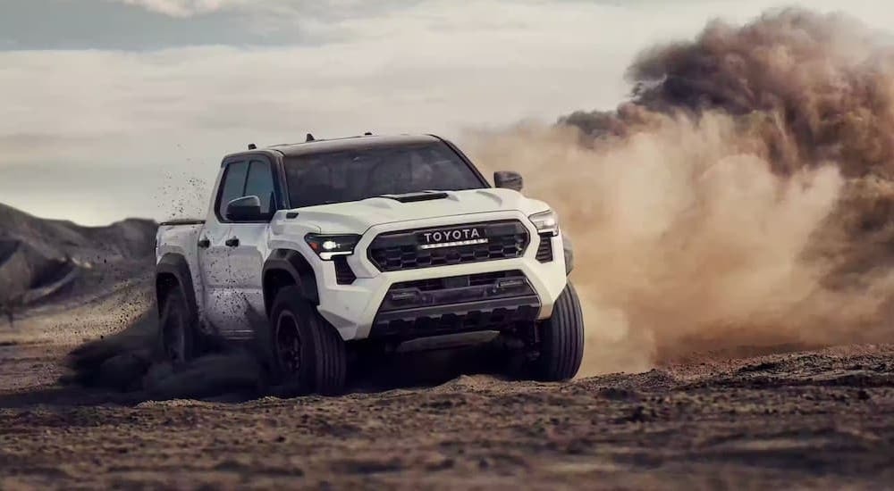 A white 2024 Toyota Tacoma TRD is shown from the front at an angle.