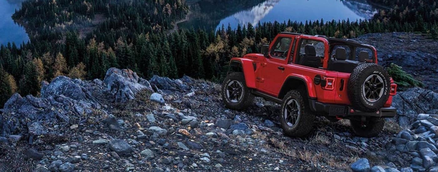 A red 2020 Jeep Wrangler Rubicon is shown from the rear at an angle after leaving a dealer that has a used Jeep for sale.