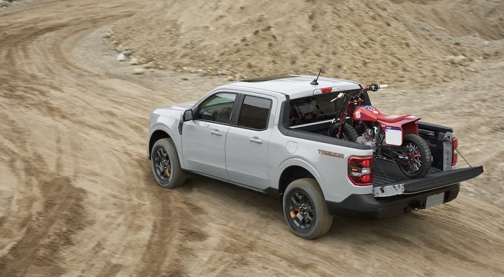 A grey 2024 Ford Maverick Tremor is shown from the rear at an angle.