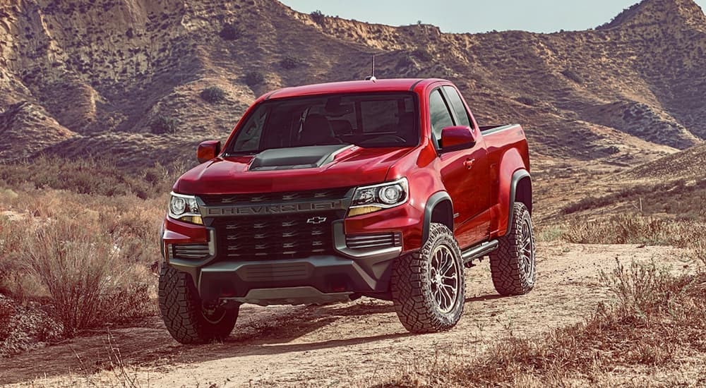 A red 2021 Chevy Colorado ZR2 is shown from the front at an angle after leaving a dealer that has used Chevy trucks for sale..