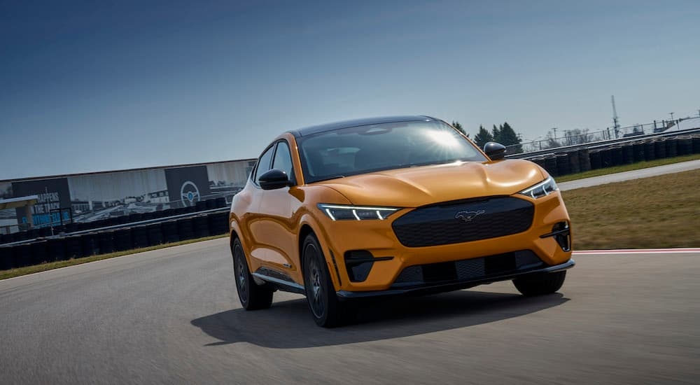 A yellow 2021 Ford Mustang Mach-E GT is shown from the front at an angle.