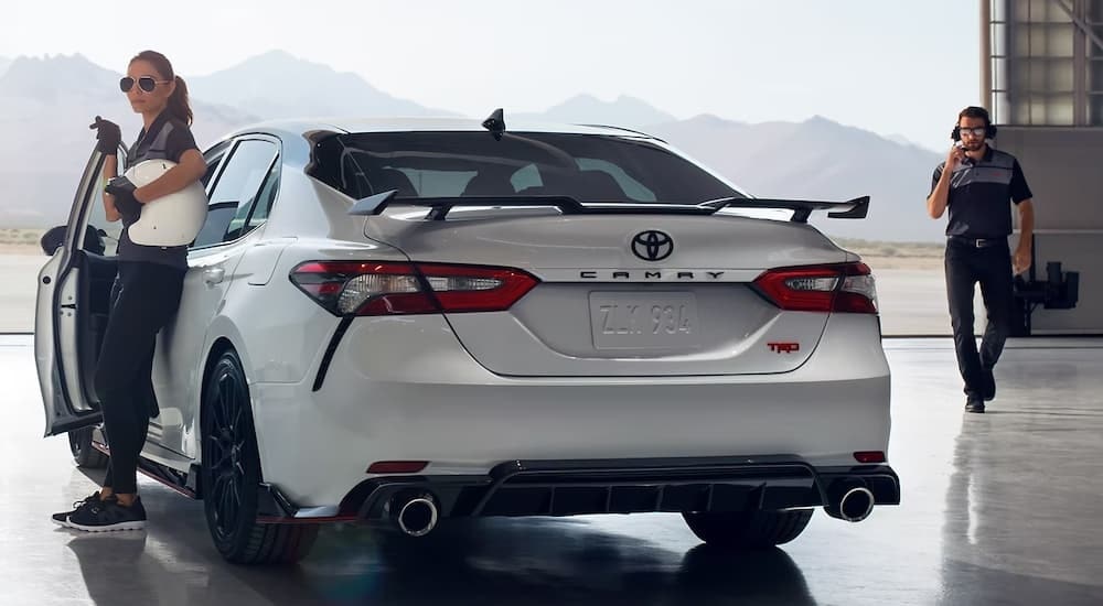 A white 2021 Toyota Camry TRD is shown from the rear at an angle after leaving a used Toyota dealer.