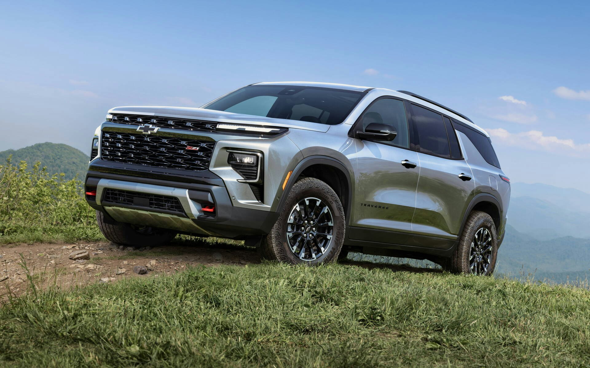 Chevrolet Traverse 2024 Chevy Traverse driving up a grassy hill