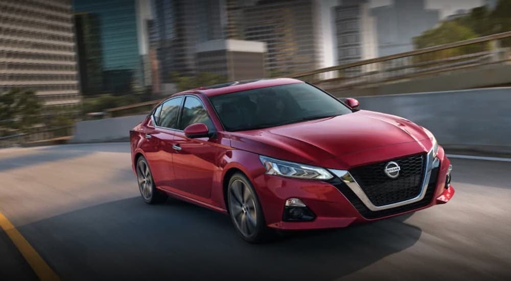 A red 2021 Nissan Altima is shown from the front at an angle.