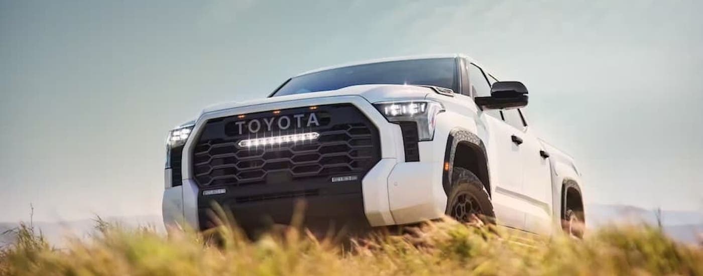 A white 2022 Toyota Tundra is shown from the front at an angle after leaving a dealer that has a Toyota Tundra for sale.