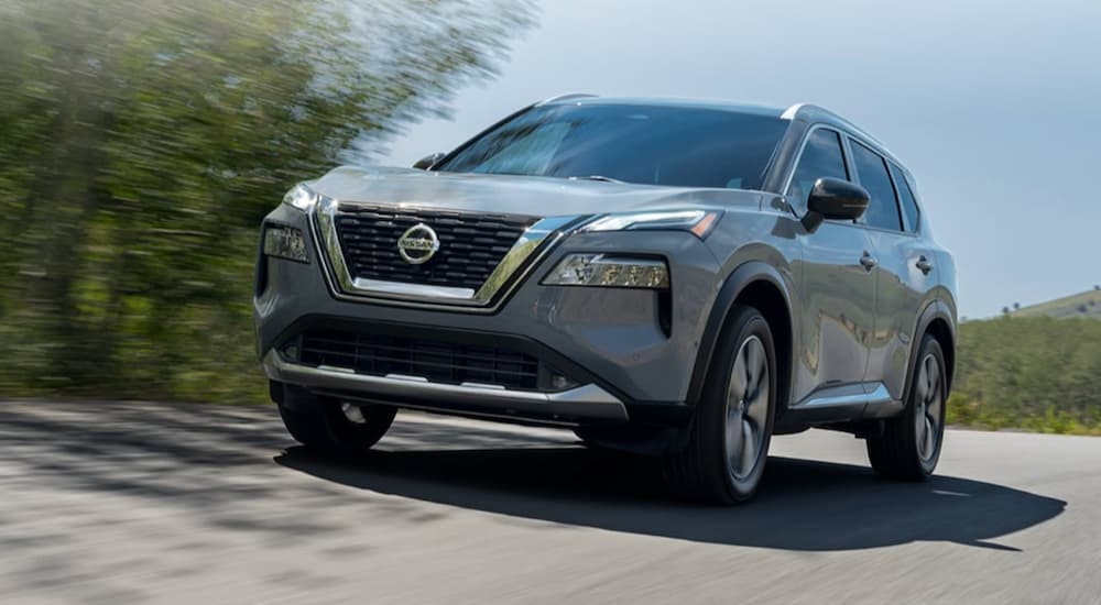 A grey 2022 Nissan Rogue is shown from the front at an angle after leaving a dealer that has used Nissans for sale.