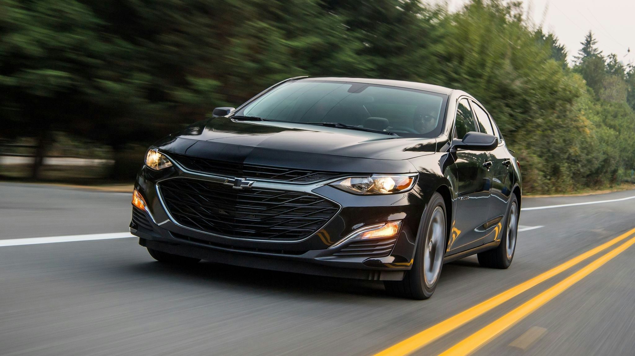 2024 Chevrolet Malibu driving down a road