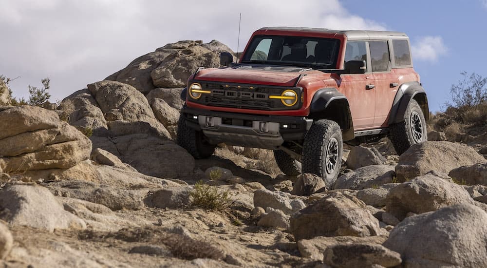 A 2024 Ford Bronco Raptor is shown from the front at an angle.