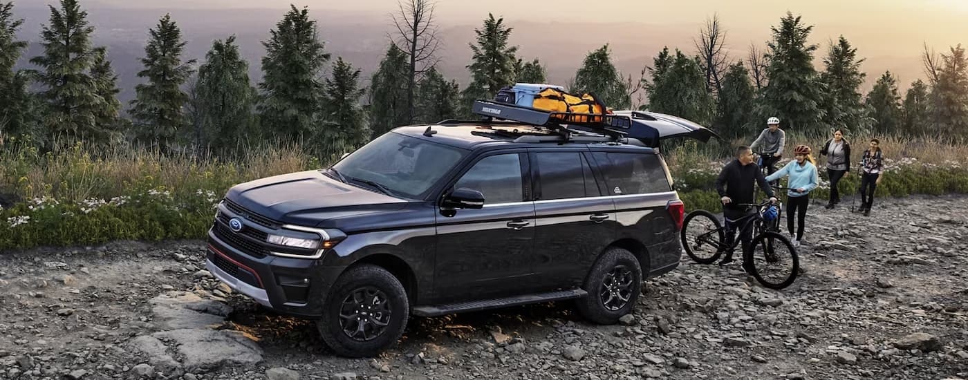 A black 2024 Ford Expedition Timberline is shown parked on a rocky trail.