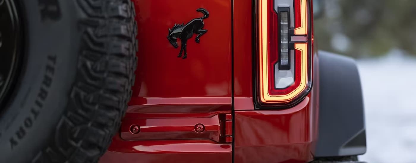 A close up of the taillight on a red 2024 Ford Bronco Wildtrak is shown.