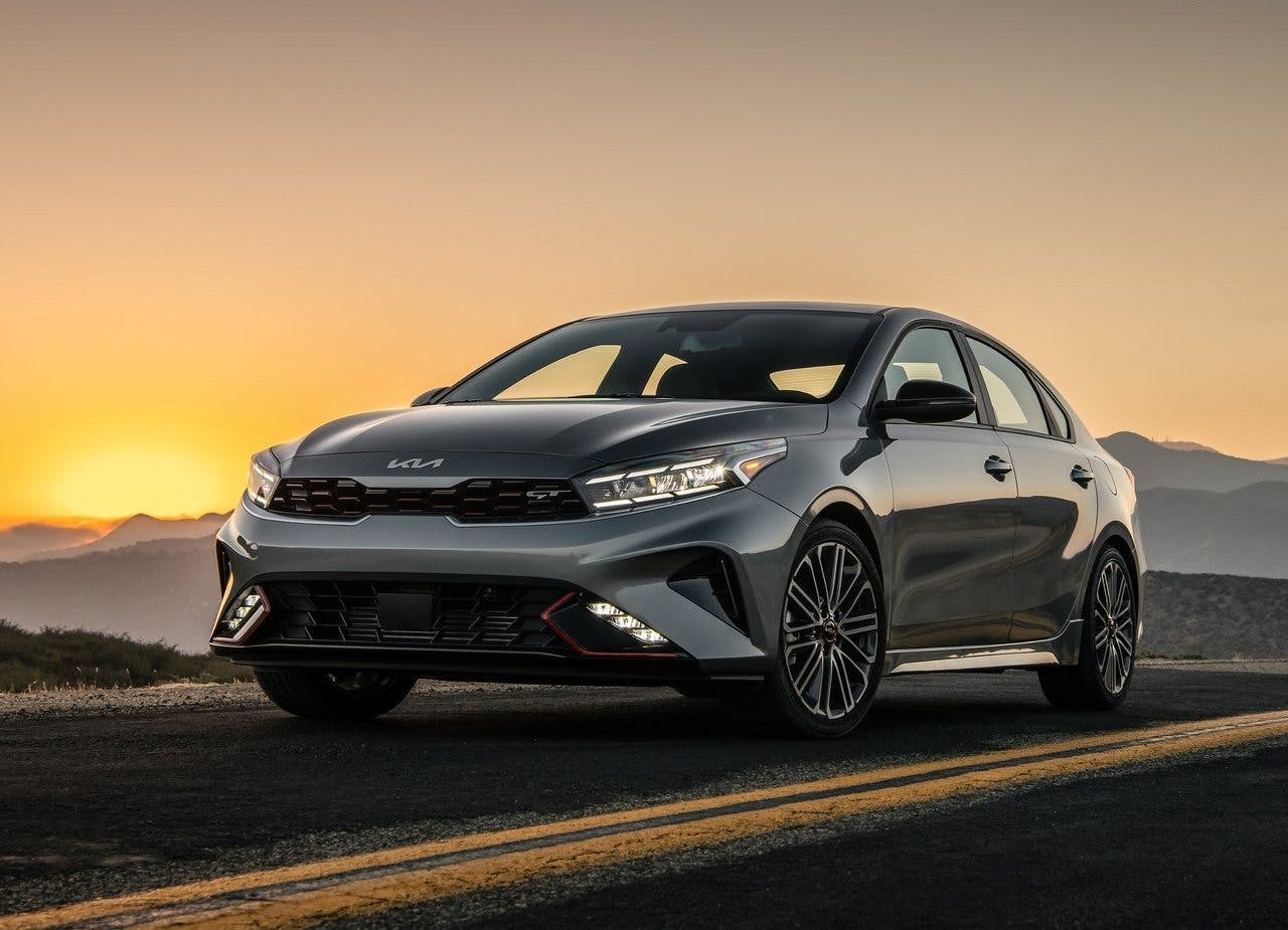 2024 KIA FORTE GT on a road at sunset