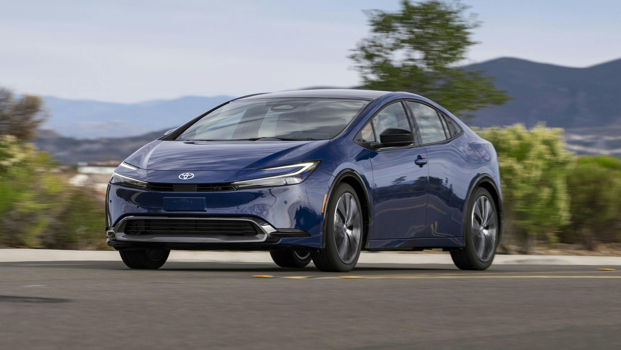 2023-toyota-prius-drive-1-1670883063 2023 Toyota Prius driving on a street