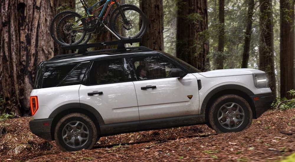 A white 2024 Ford Bronco Sport is shown from the side while hauling bikes.