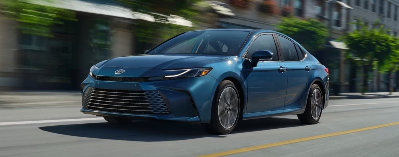 A blue 2025 Toyota Camry is angled left.