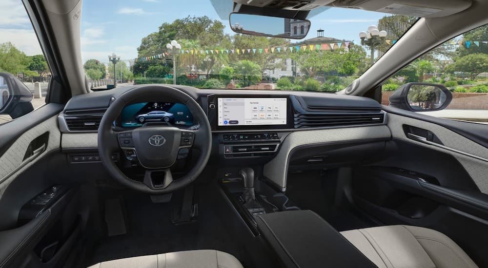 the tan interior of a 2025 Toyota Camry is shown from the driver's seat.