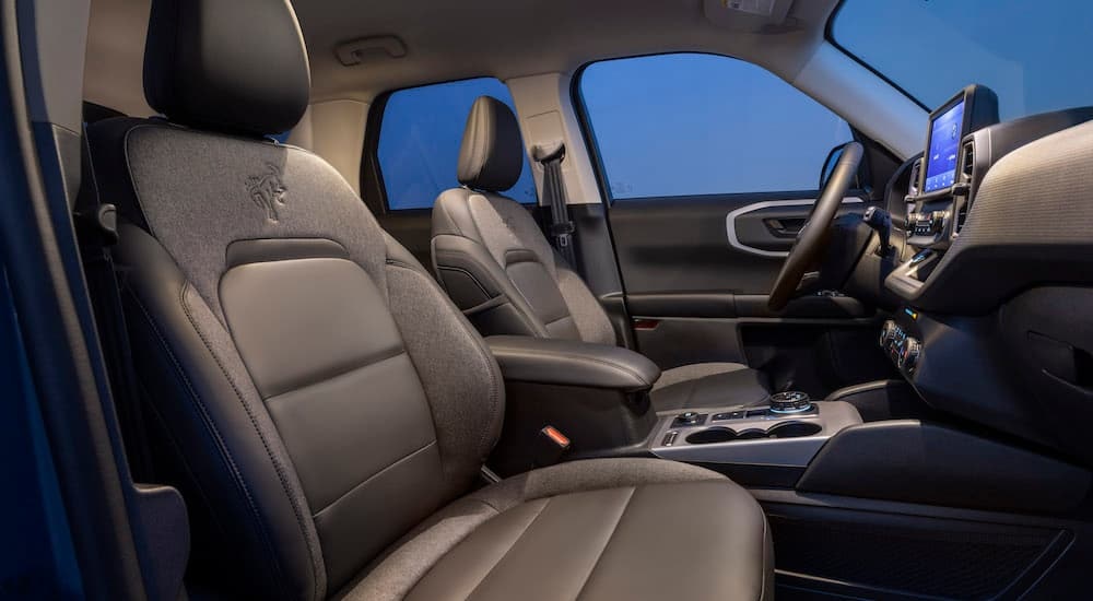 The black interior of a 2024 Ford Bronco Sport is shown from the passenger side.