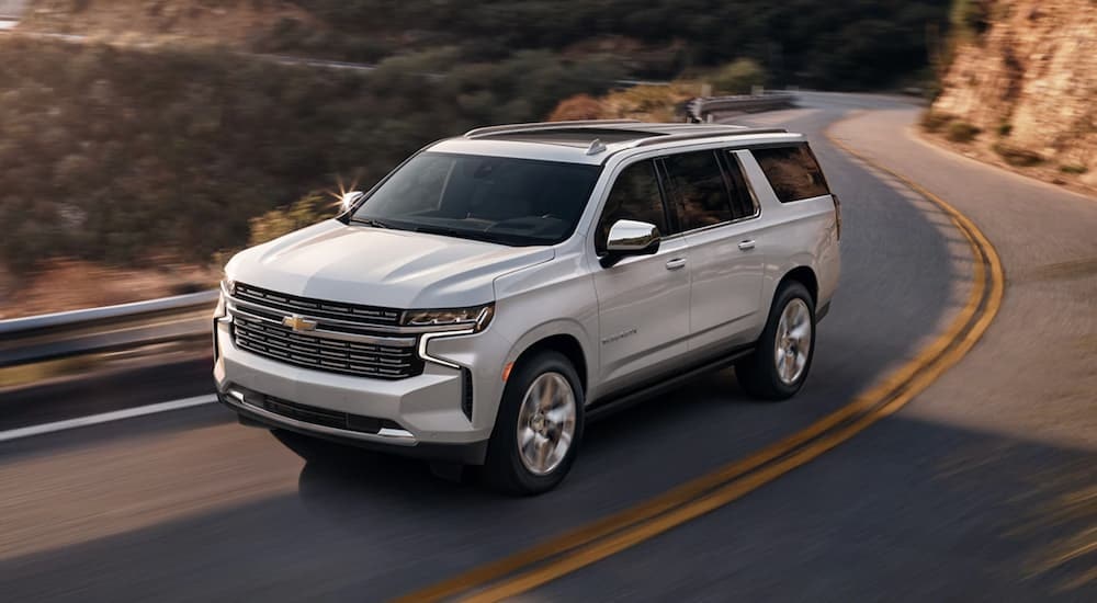A white 2021 Chevy Suburban is shown from the front at an angle.