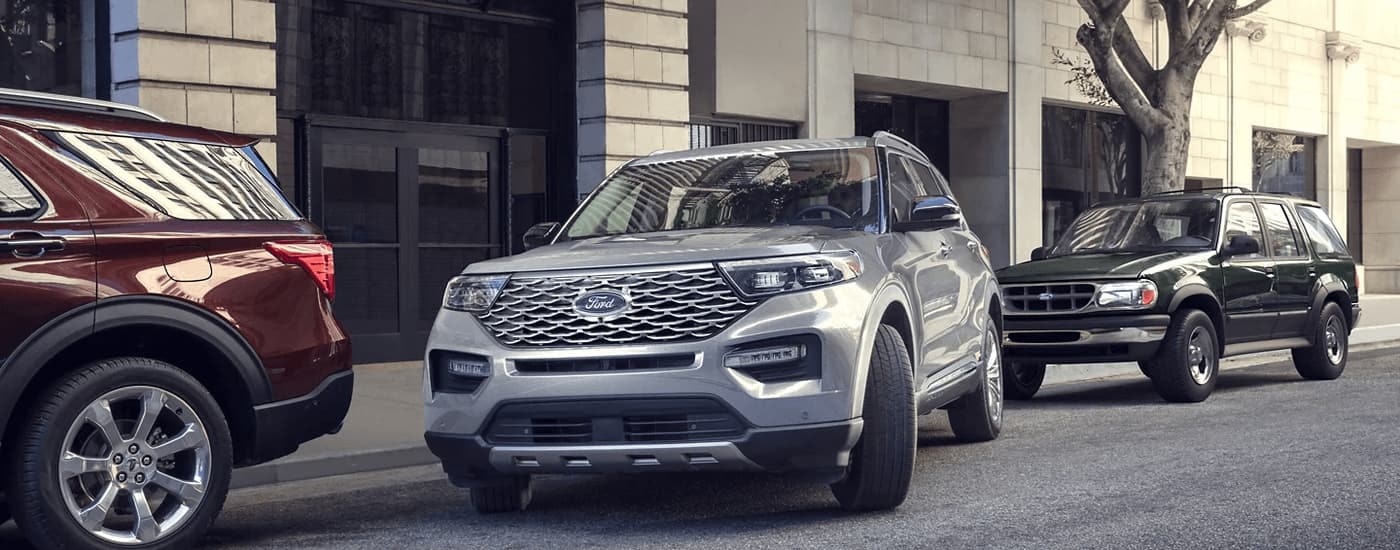 A silver 2023 Ford Explorer is shown from the front at an angle after leaving a dealer that has used SUVs for sale.