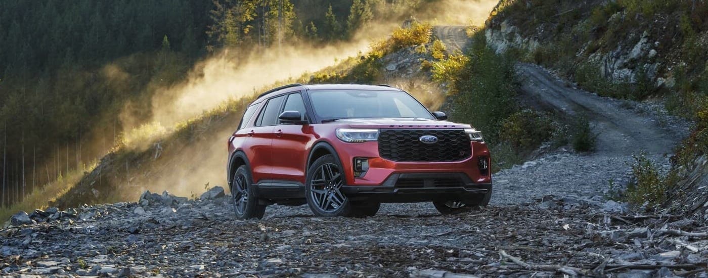 A red 2025 Ford Explorer ST is shown parked on an off-road trail.