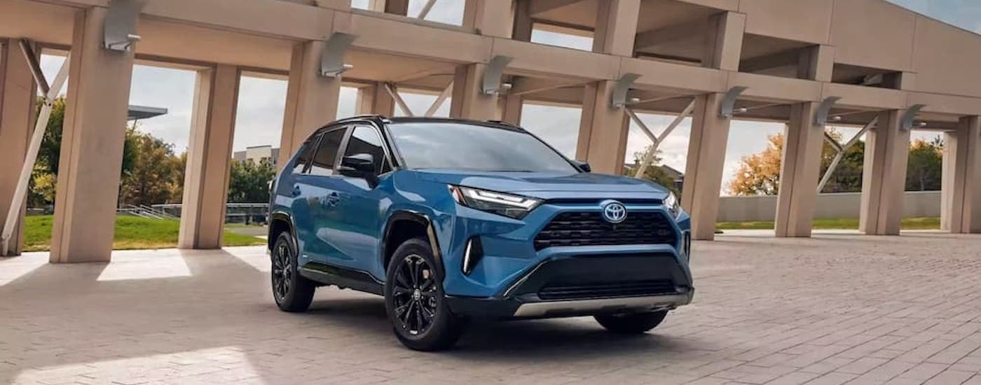 A blue 2023 Toyota RAV4 Prime is shown from the front at an angle after leaving a Toyota dealership.