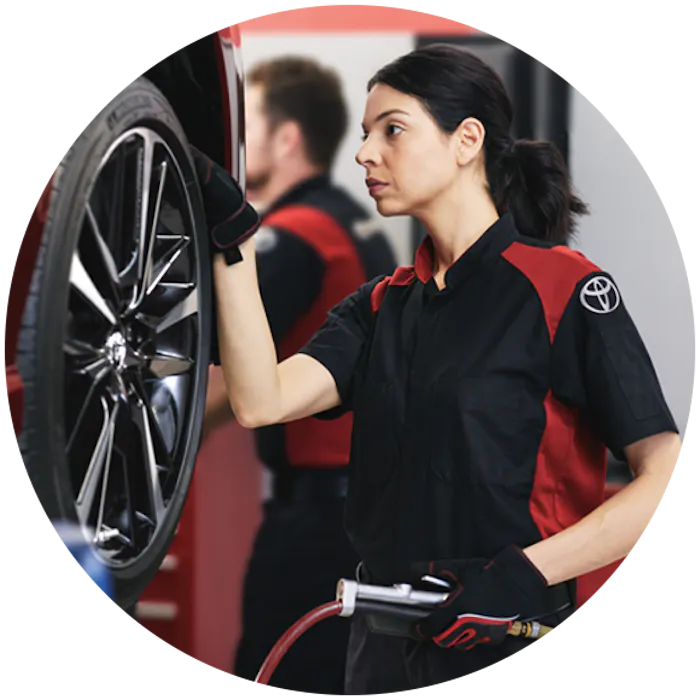 Service technician diagnosing a vehicle