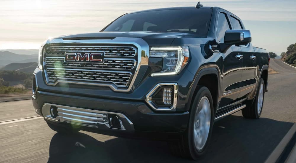 A grey 2021 GMC Sierra 1500 Denali is shown from the front at an angle after leaving a dealer that has used trucks for sale in Westminster.