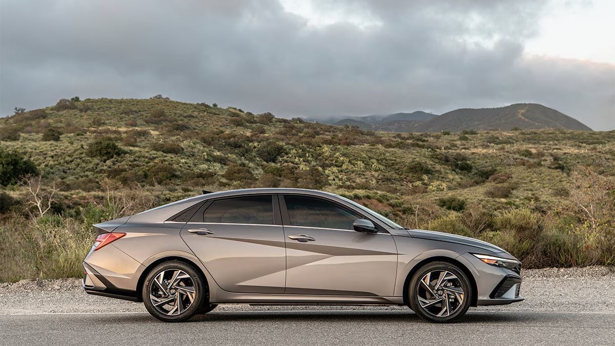 2024-hyundai-elantra-right 2024 Hyundai Elantra parked in front of a grassy field