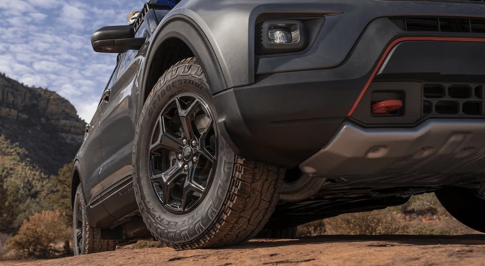 A close up of the tire and side on a grey 2024 Ford Explorer Timberline.