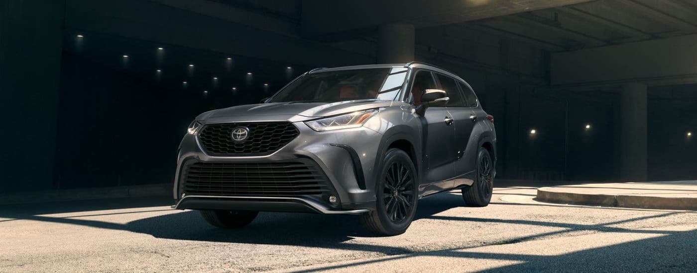 A silver 2024 Toyota Highlander XSE driving through a parking garage.