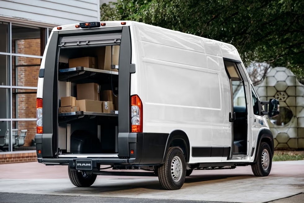 Ram ProMaster EV delivering packages to a business