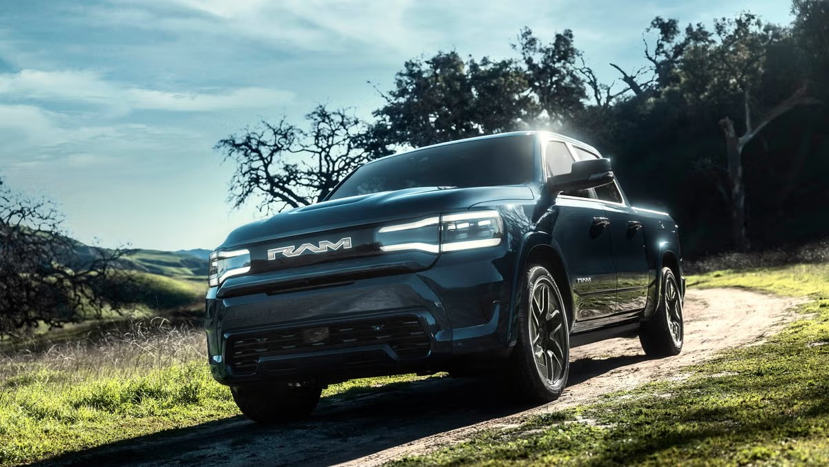 if23jcv9 Ram EV Truck driving down a dirt road