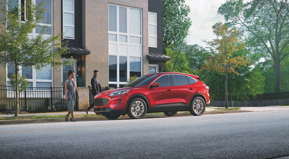 A red 2022 Ford Escape is shown from the side after leaving a dealer that has a used Ford for sale.