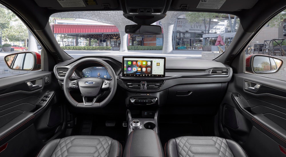 The black interior of a 2023 Ford Escape ST-Line is shown from above the center console.