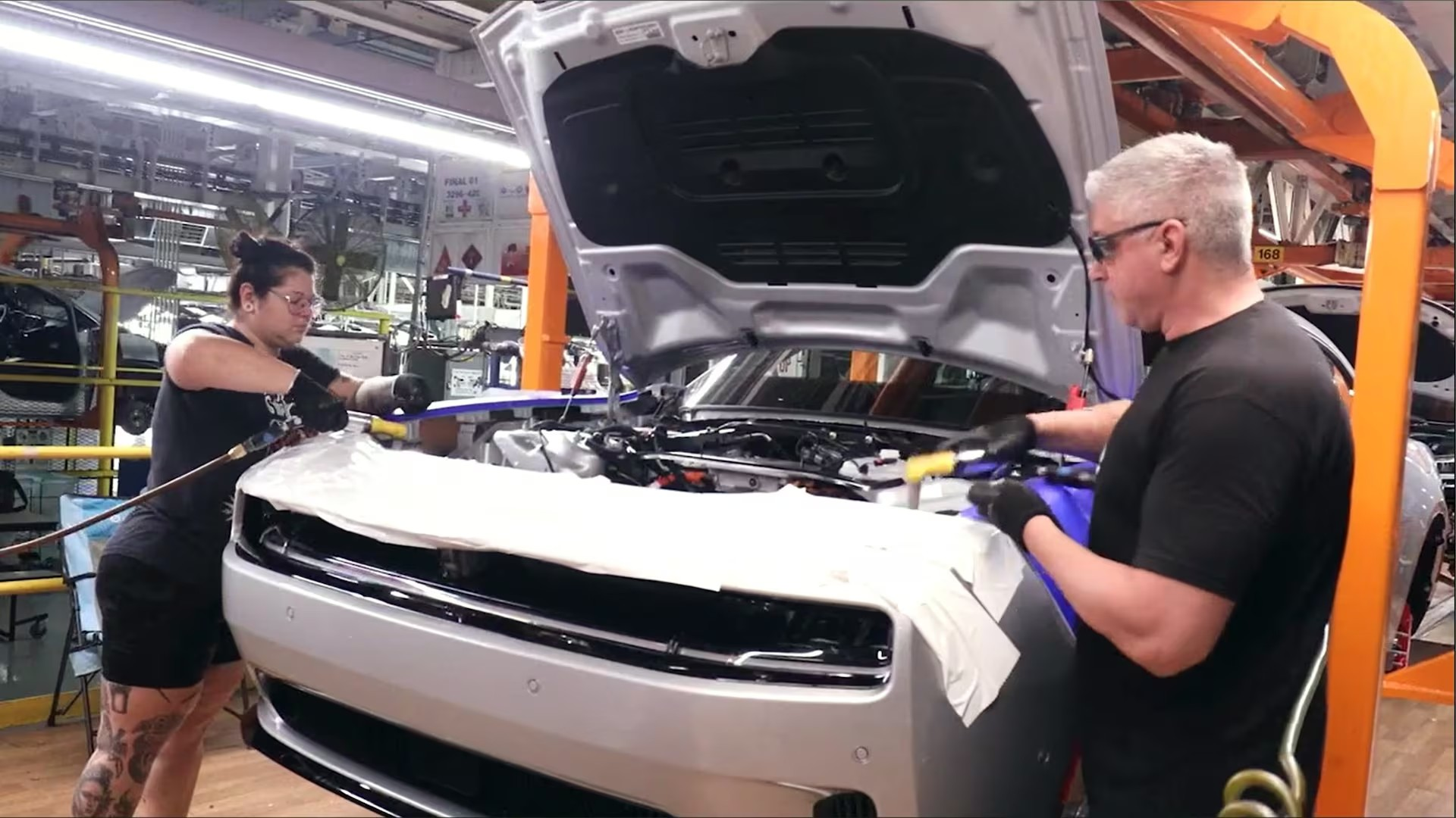 Two workers working on the 2025 Charger Daytona