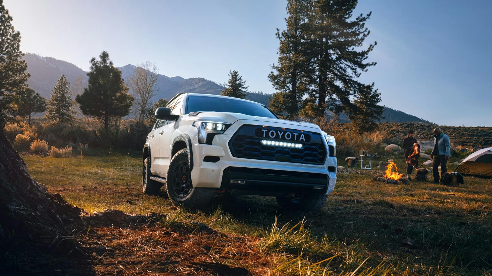 ez5kfgnr 2025 Sequoia TRD Pro parked in the woods by a couple camping