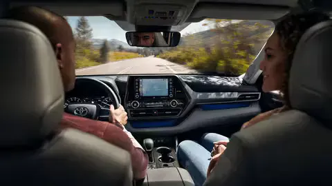  Couple driving in a new Toyota