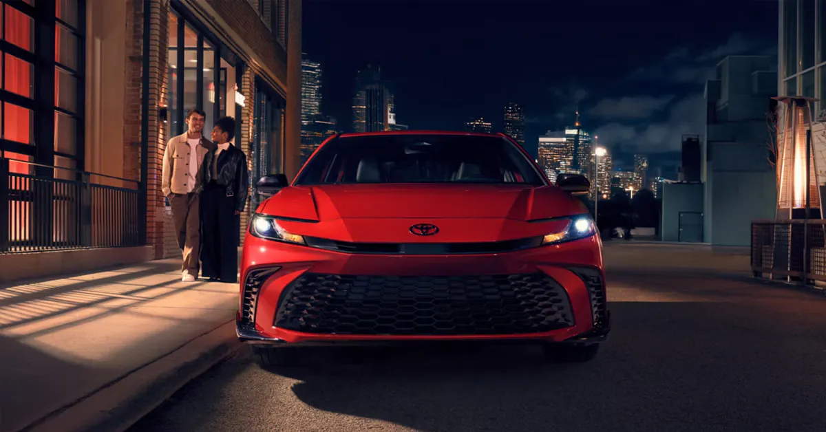 2026 Toyota Camry sedan parked on a city street at night.