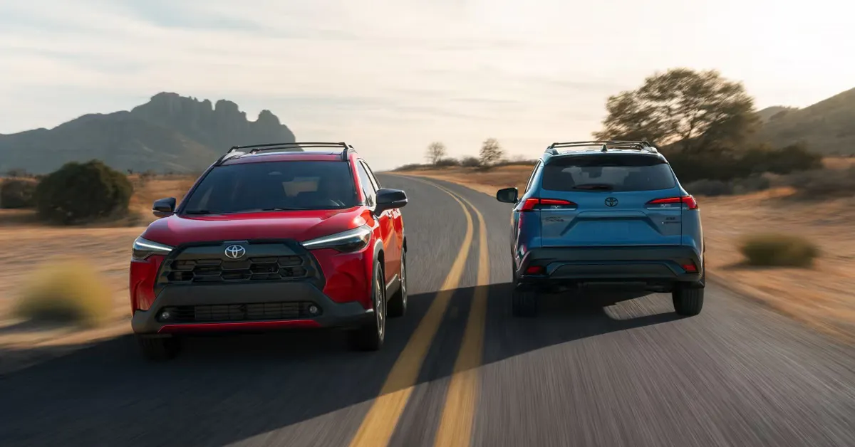 2026 Toyota Corolla Cross SUVs driving side by side on a scenic desert highway