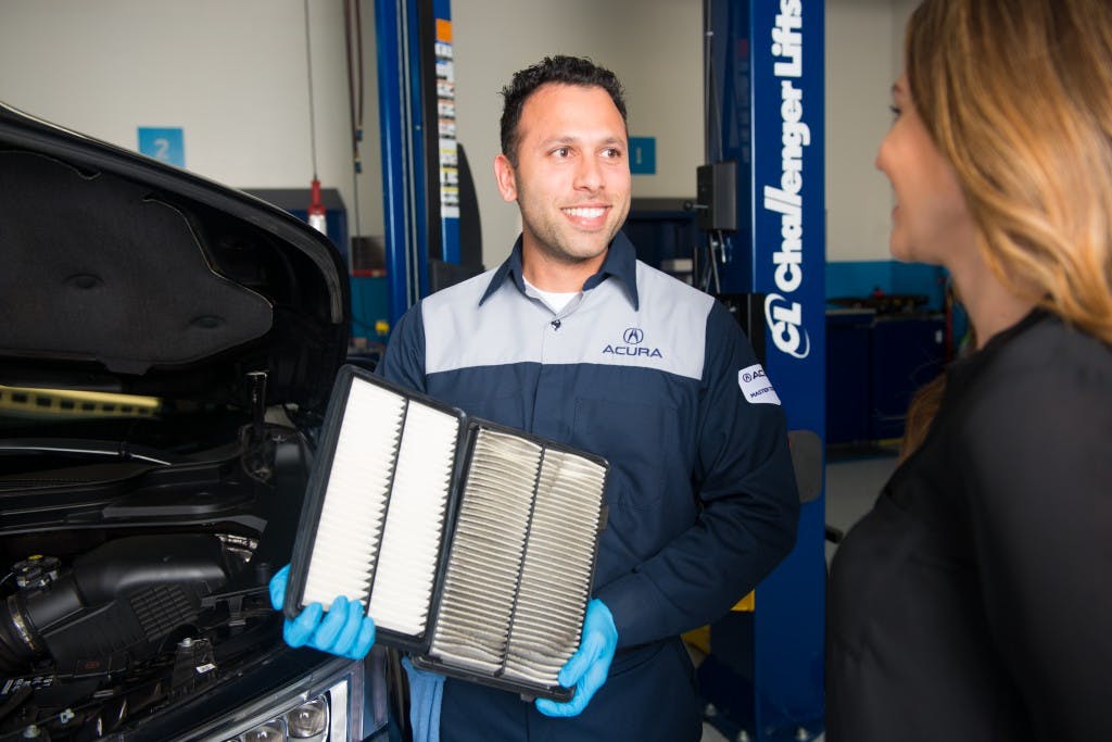 service technician showing dirty and clean air filters