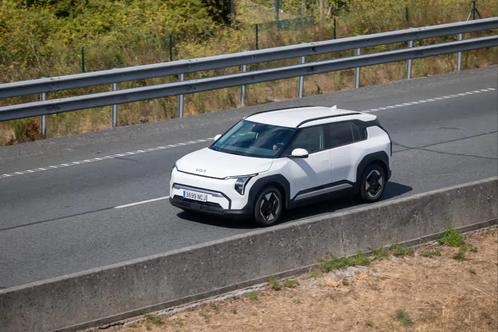 white EV6 driving on a road