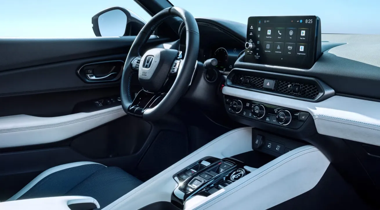 Honda vehicle interior featuring a touchscreen infotainment display, multifunction steering wheel, and center console controls.