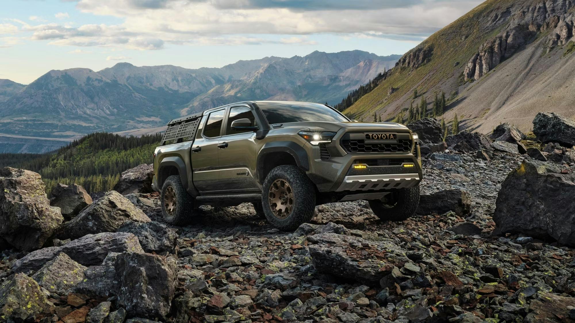 2024 double cab 5 foot long bed TrailHunter Tacoma parked on a bed of rocks