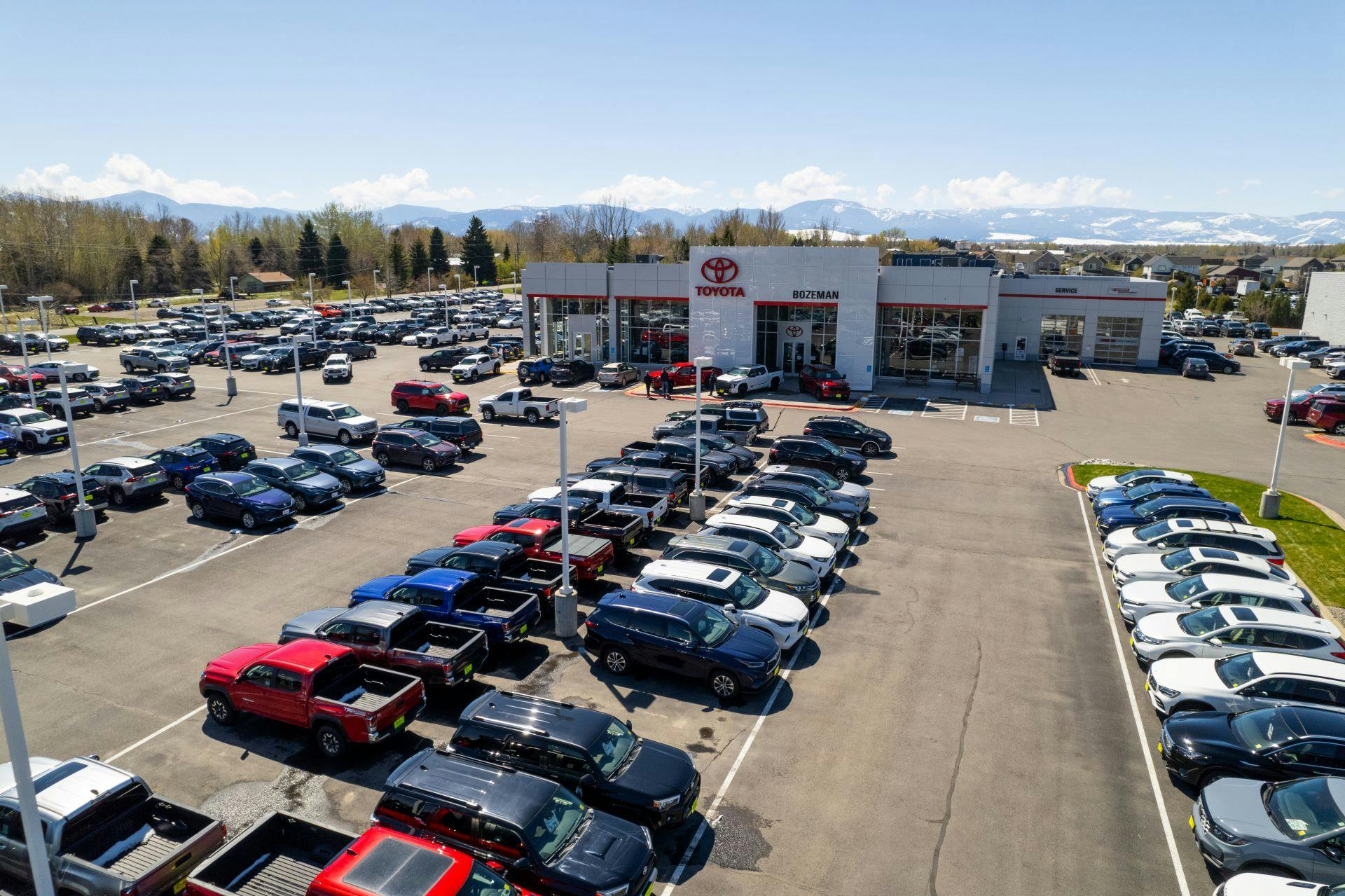 Birds eye view of Toyota of Bozeman car lot full of new used and rental trucks, SUV's and sedans.