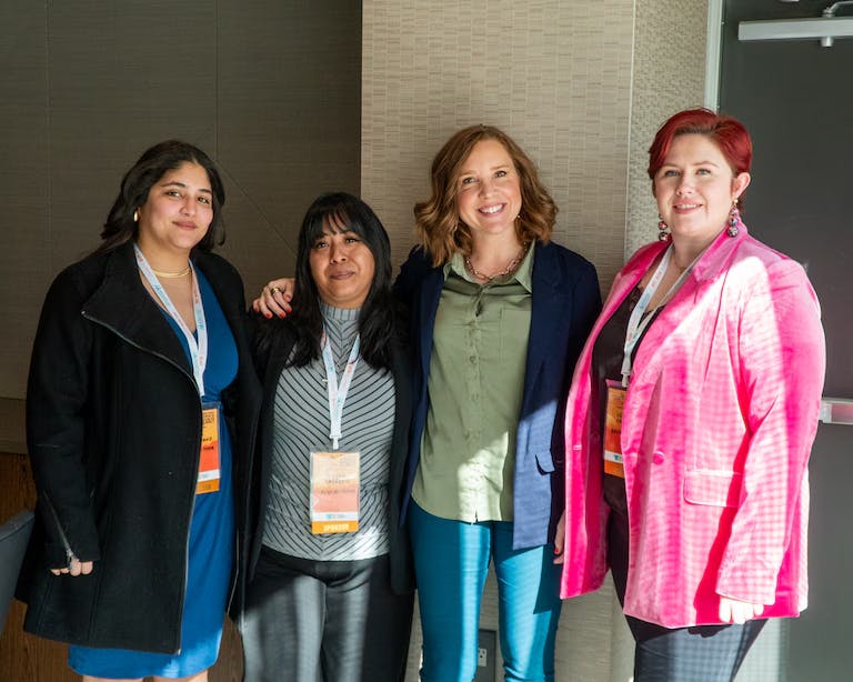 4 women together at women in business summit