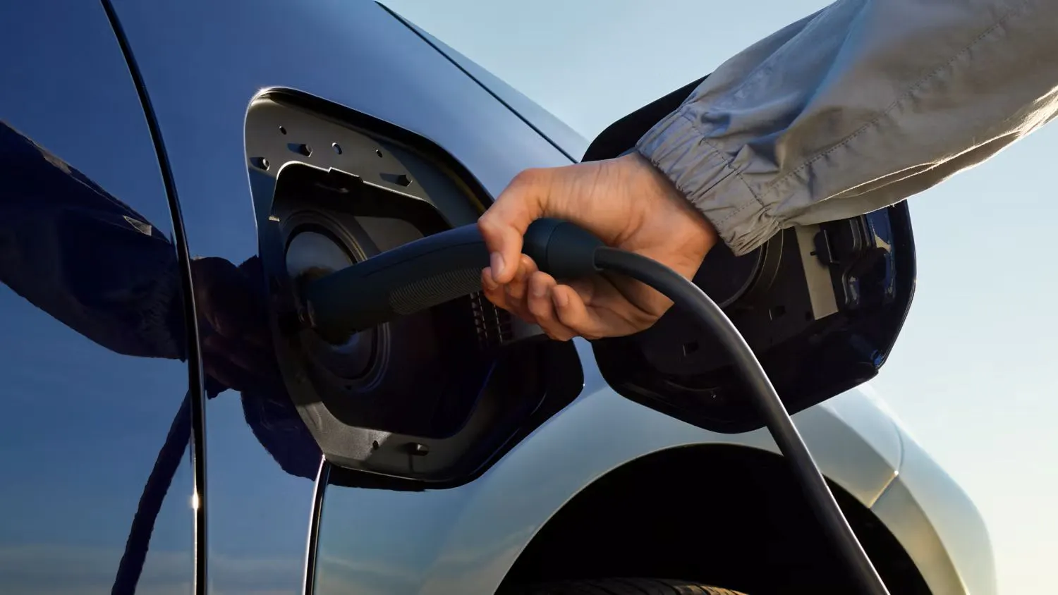 Toyota EV charging port being plugged in