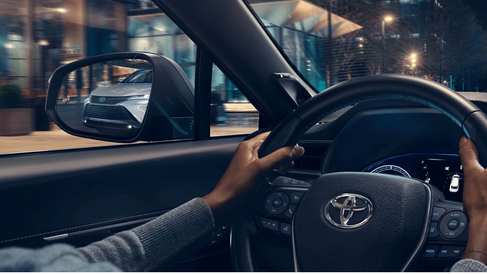 Hands on Toyota steering wheel.