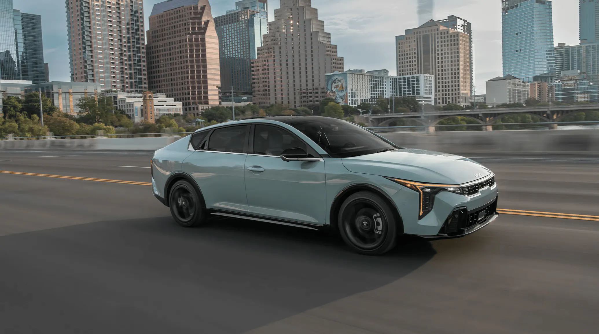 Kia K4 driving in the city