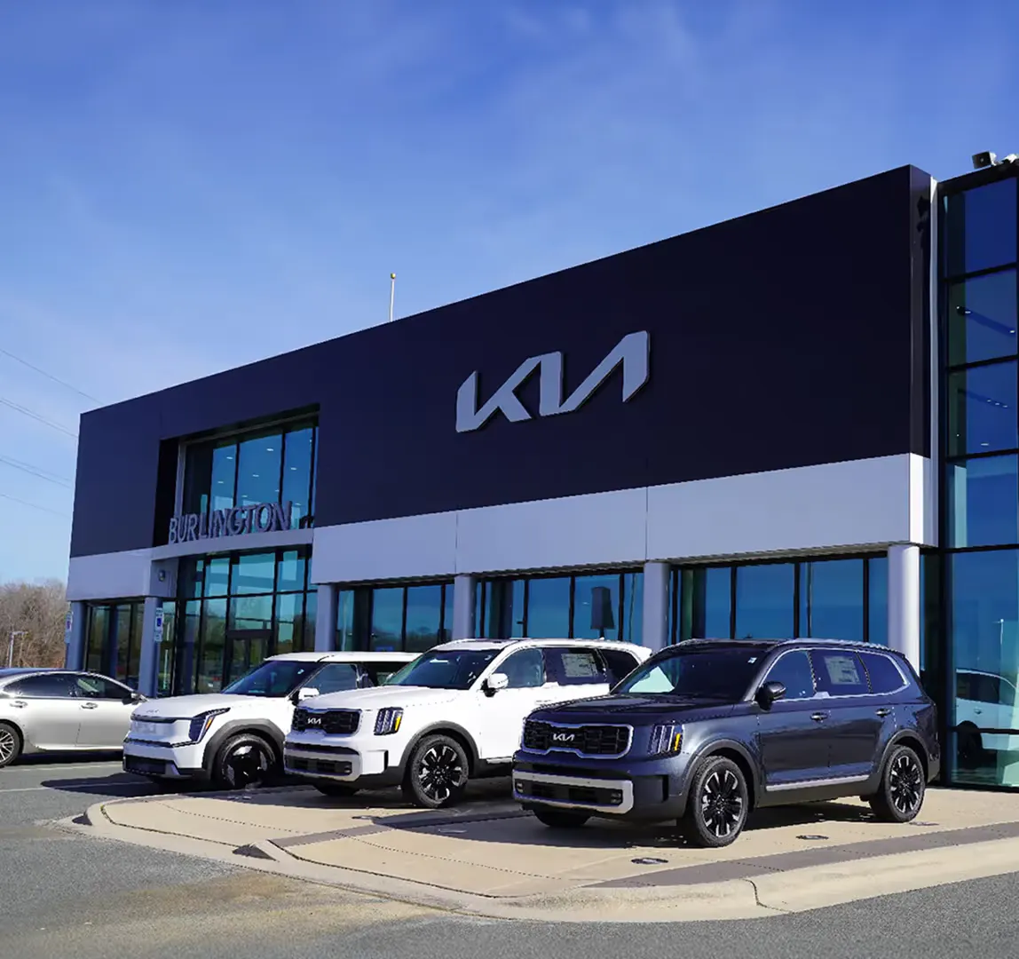 Exterior of the dealership building with vehicles displayed outside
