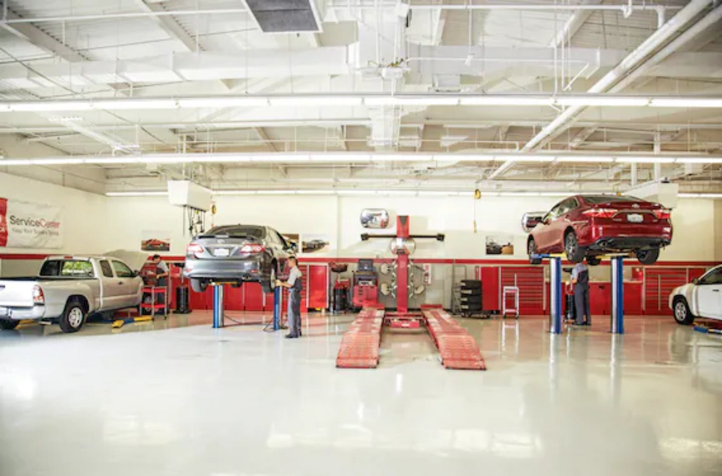 service garage with vehicles on rack